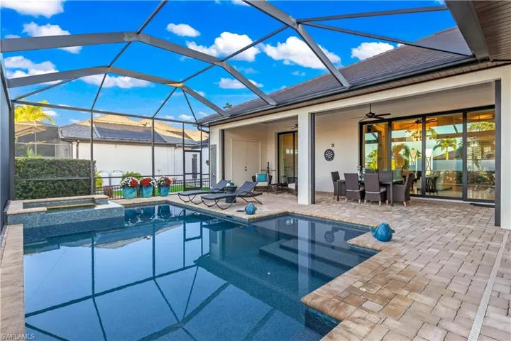 Heated pool and spa oasis with ambient lighting, perfect for unwinding while enjoying serene canal views or stunning sunsets.