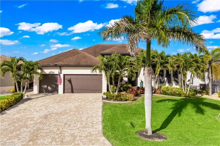 Front aerial showcasing the house, driveway, and surrounding greenery, offering a complete view of the home’s curb appeal and refined exterior.