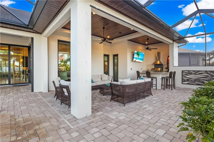 Alfresco cooking and dining area featuring waterfront views and sunset ambiance.