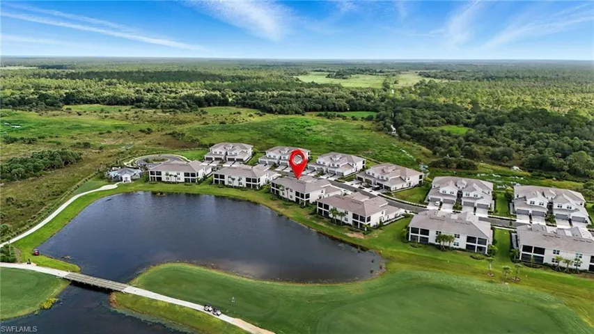 Aerial perspective of suburban area featuring a large body of water