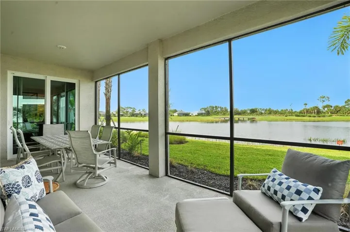 Sunroom featuring a water view
