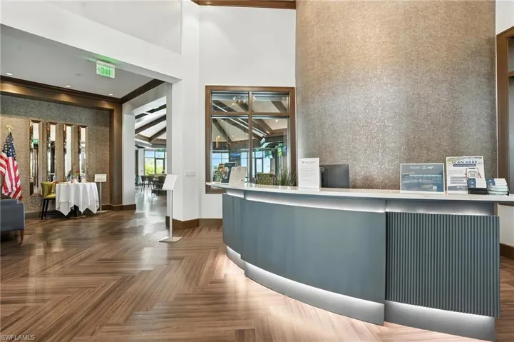 Reception area with a towering ceiling and crown molding