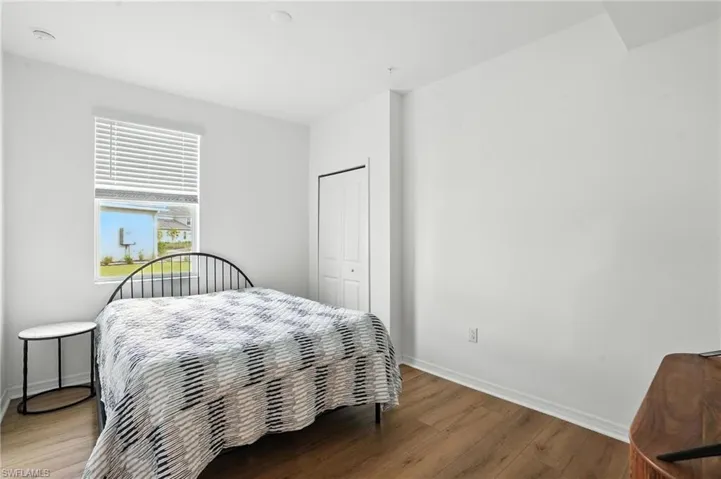 Bedroom featuring wood finished floors and a closet