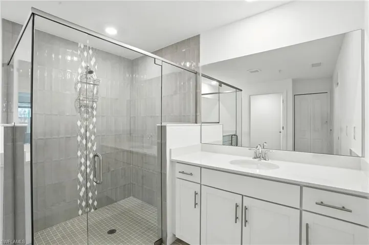 Full bath featuring vanity and a shower stall