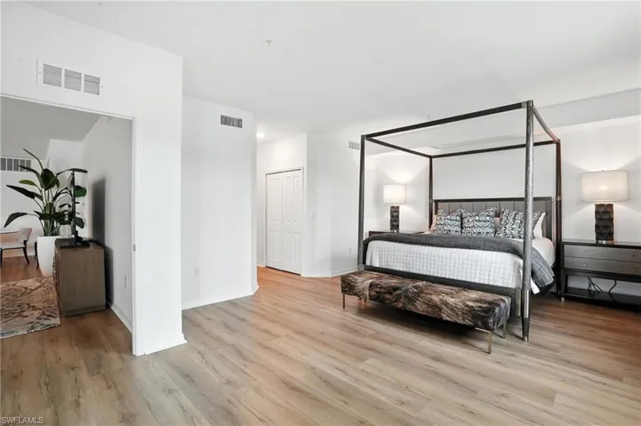 Bedroom with wood finished floors and baseboards
