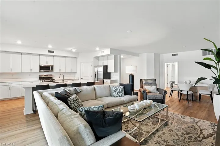 Living area with recessed lighting and light wood finished floors