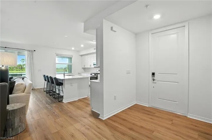 Foyer entrance featuring light wood finished floors and recessed lighting