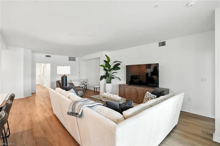 Living room featuring light wood-style flooring and baseboards