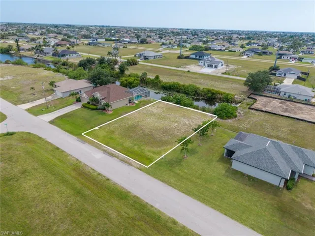 Unimproved lot featuring partial canal frontage, level topography, and a surrounding residential neighborhood
