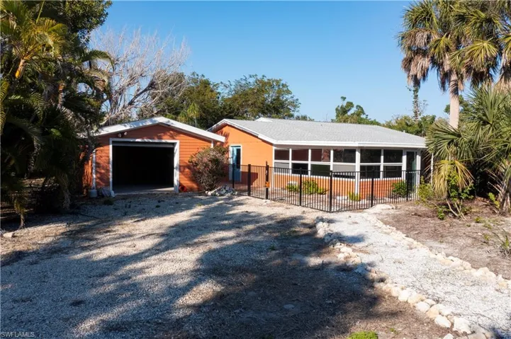 Ranch-style house featuring a garage and an outdoor structure
