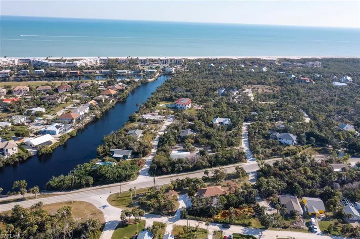 Birds eye view of property with a water view