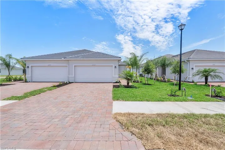 View of front of house featuring a front yard and a garage