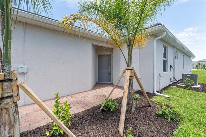 Rear view of property featuring a patio and central AC