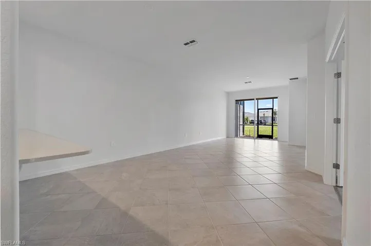 Unfurnished room featuring light tile floors