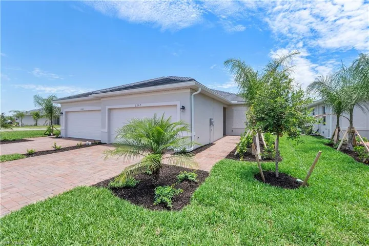 View of side of home featuring a garage and a yard