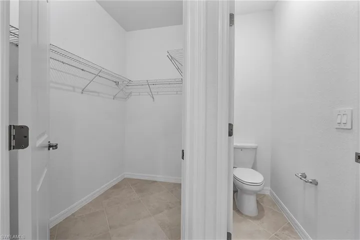 Bathroom with toilet and tile floors