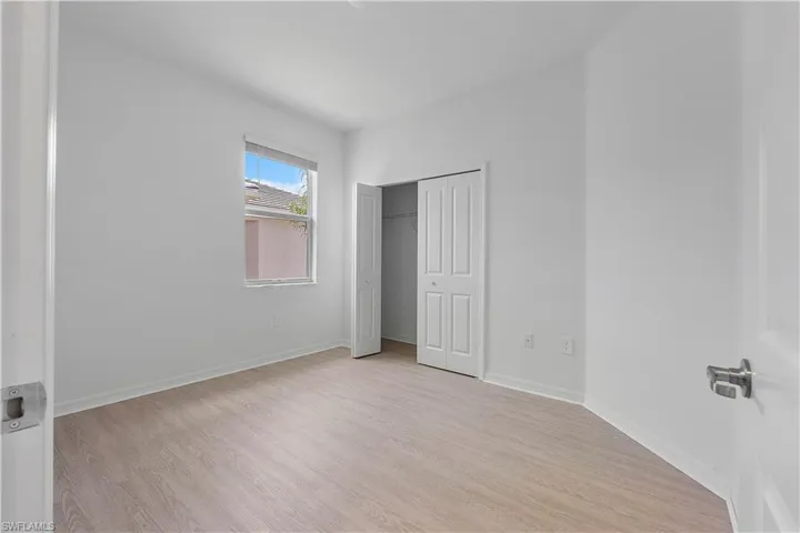 Unfurnished bedroom with a closet and light wood-type flooring