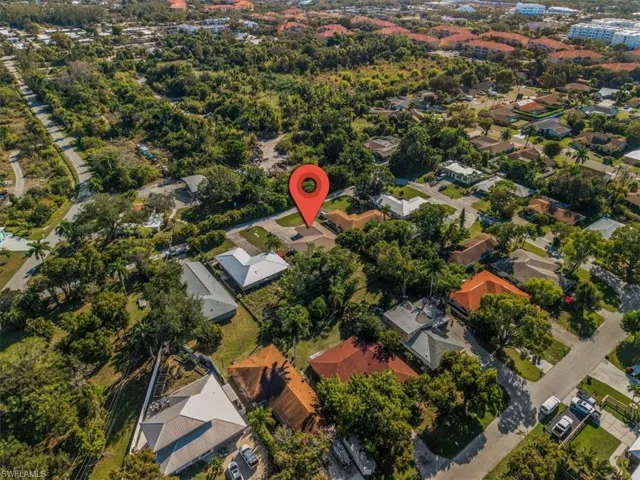 Aerial view of property's location with nearby suburban area