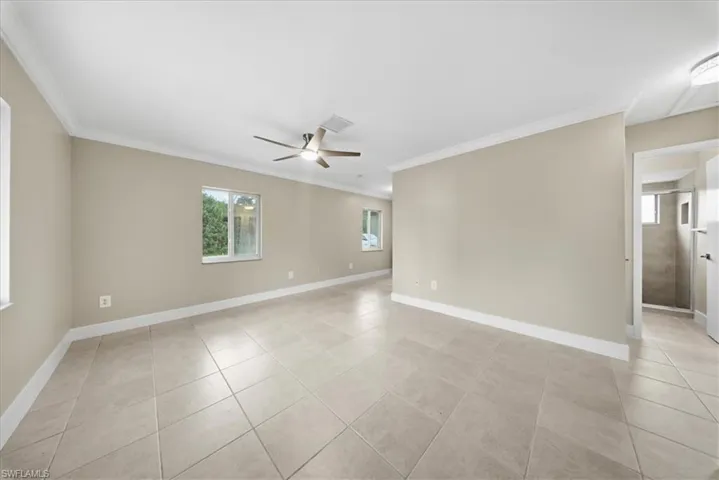 Second Unit-Unfurnished room featuring crown molding, ceiling fan, and light tile patterned flooring