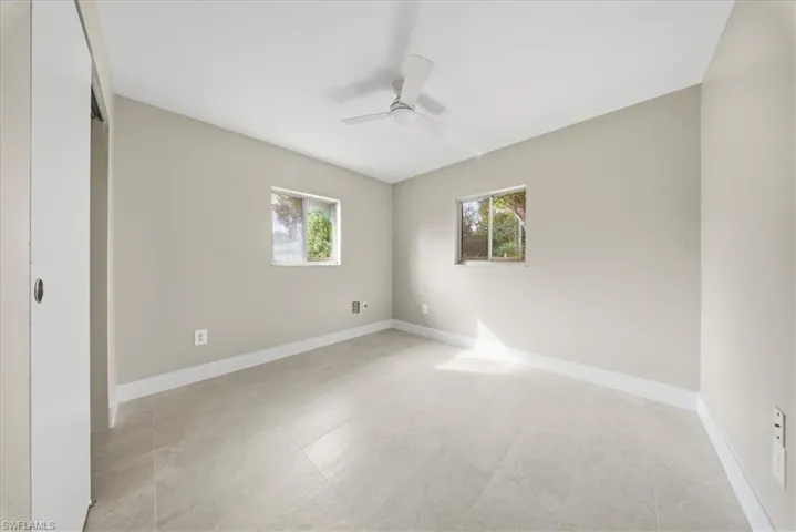 Spare room featuring baseboards and a ceiling fan