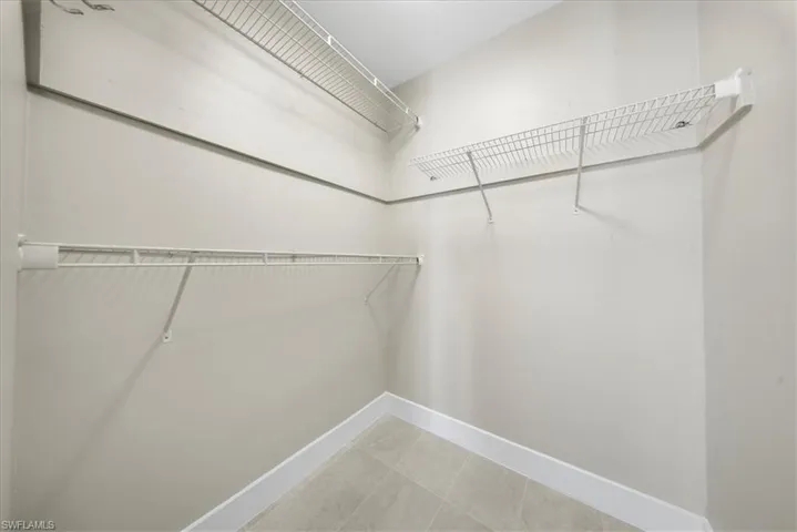 Spacious closet featuring light tile patterned flooring