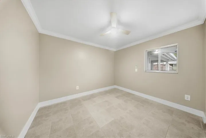 Second Unit-Spare room with ornamental molding, a ceiling fan, and light tile patterned floors