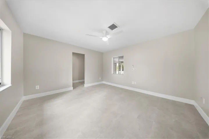 Spare room with baseboards and ceiling fan