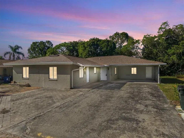 Ranch-style home with driveway, stucco siding, and a shingled roof