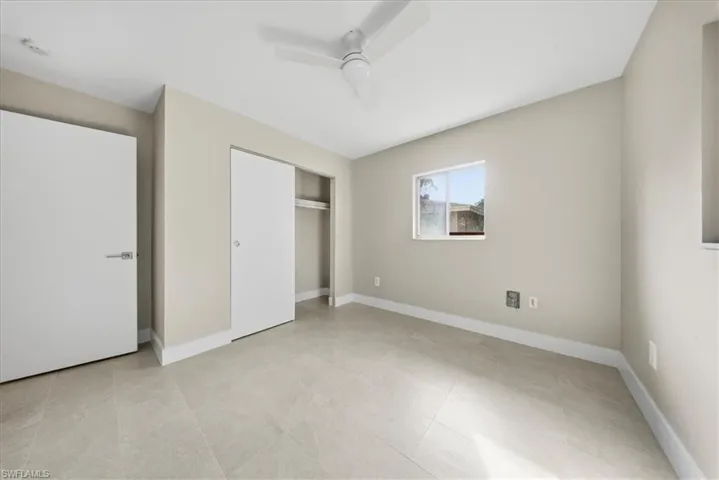 Unfurnished bedroom featuring a closet and a ceiling fan