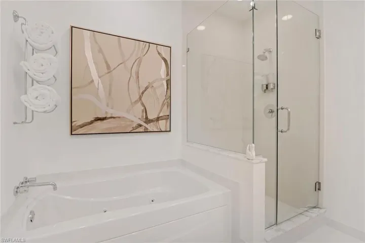 Bathroom with a glassed in shower and  jetted tub