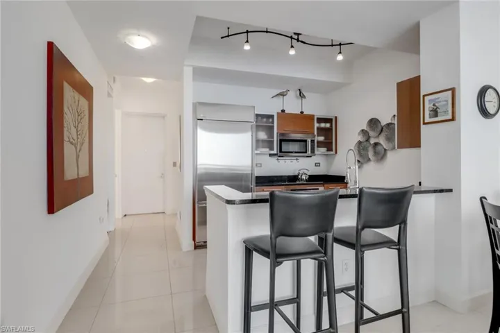 Kitchen with stainless steel appliances and breakfast bar.