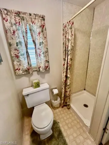 Full bathroom featuring a stall shower