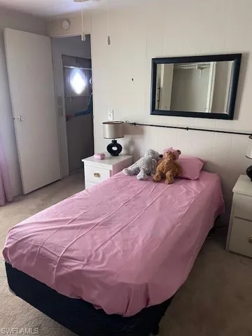 Bedroom with light colored carpet
