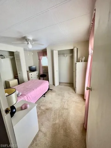 Bedroom with light carpet and ceiling fan