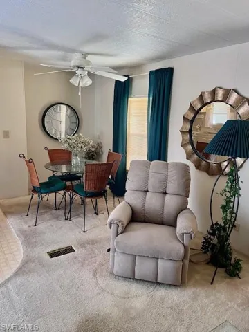 Dining area featuring carpet and a ceiling fan