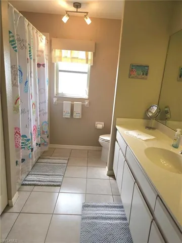 Bathroom has a combination tub and shower.