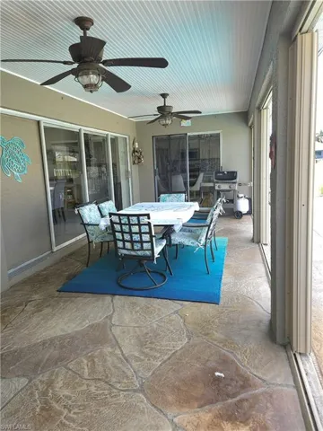 Sunroom featuring ceiling fan
