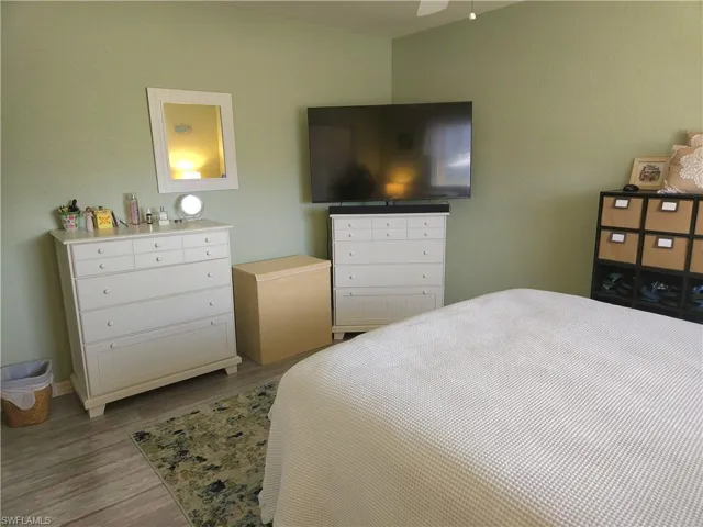 Queen-sized Bedroom#3 featuring ceiling fan and light wood-type flooring