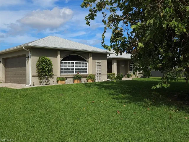 Featuring a side entry 2 car garage, this home has both sun and shade with many flowering and fruit tress in the front and back yards.