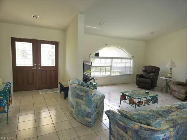 Enter the double-wide front doors into a floorplan which seamlessly flows from living room to the dining area and kitchen. An abundance of natural light, high ceilings and tile flooring throughout.