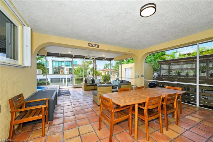 Dining room featuring plenty of natural light, a textured ceiling, and tile patterned floors