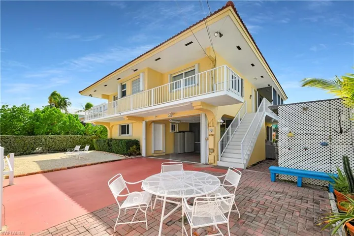 Rear view of house featuring a patio and a balcony