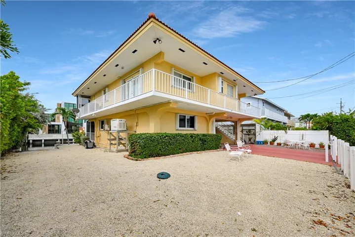 View of front facade featuring a patio area and a balcony