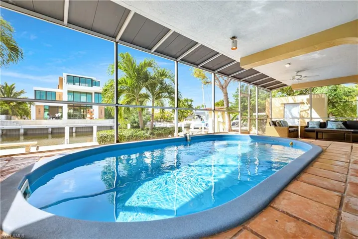 View of pool with glass enclosure
