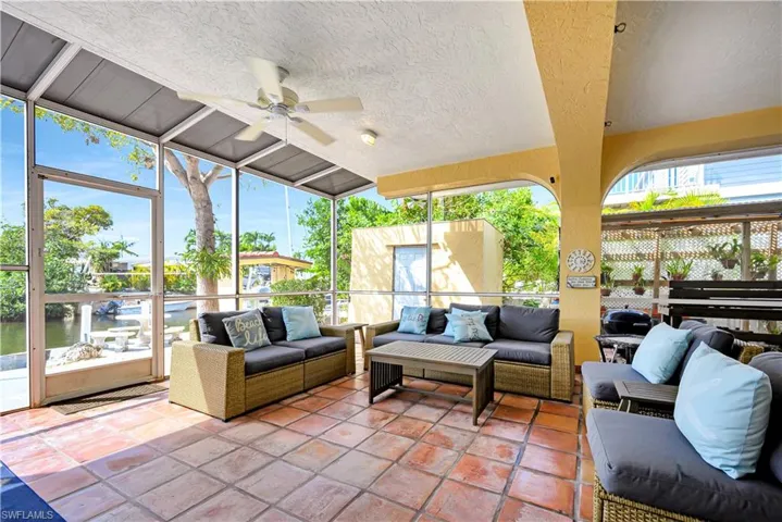 Sunroom / solarium featuring a wealth of natural light, lofted ceiling, and ceiling fan