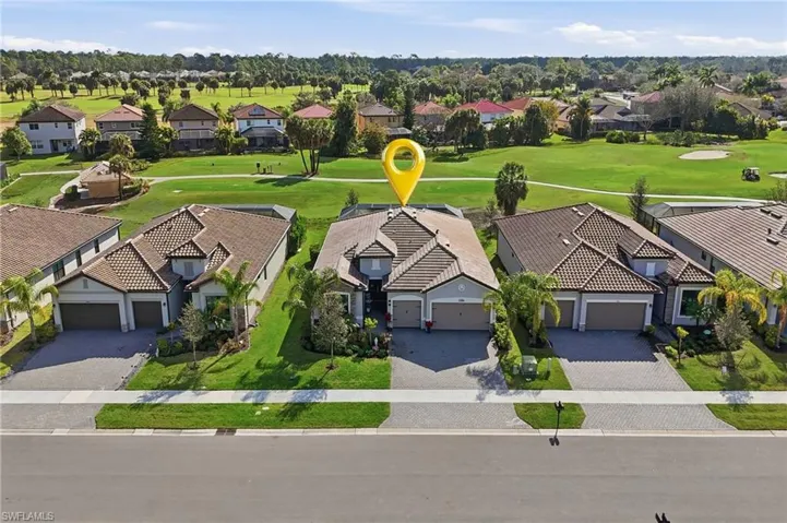 Aerial view of residential area featuring a golf club