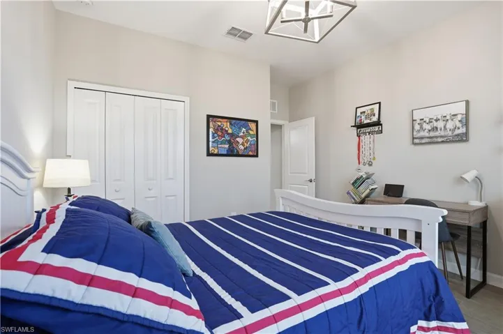 Bedroom featuring a chandelier and a closet