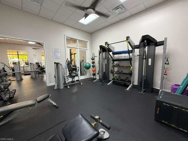 Workout area featuring a drop ceiling and a ceiling fan