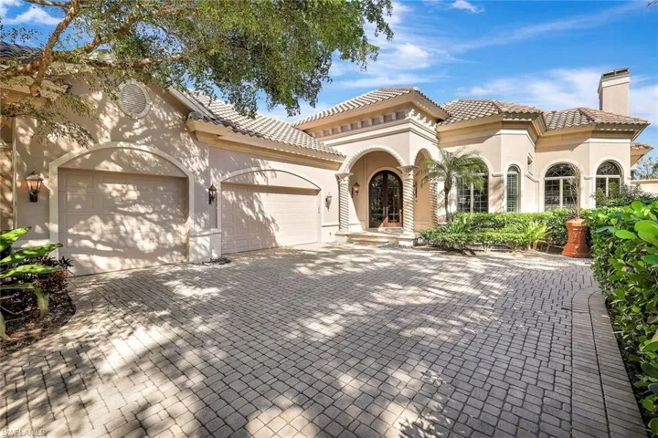 Mediterranean / spanish home with a garage