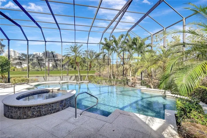 View of pool featuring a patio area, a lanai, and an in ground hot tub